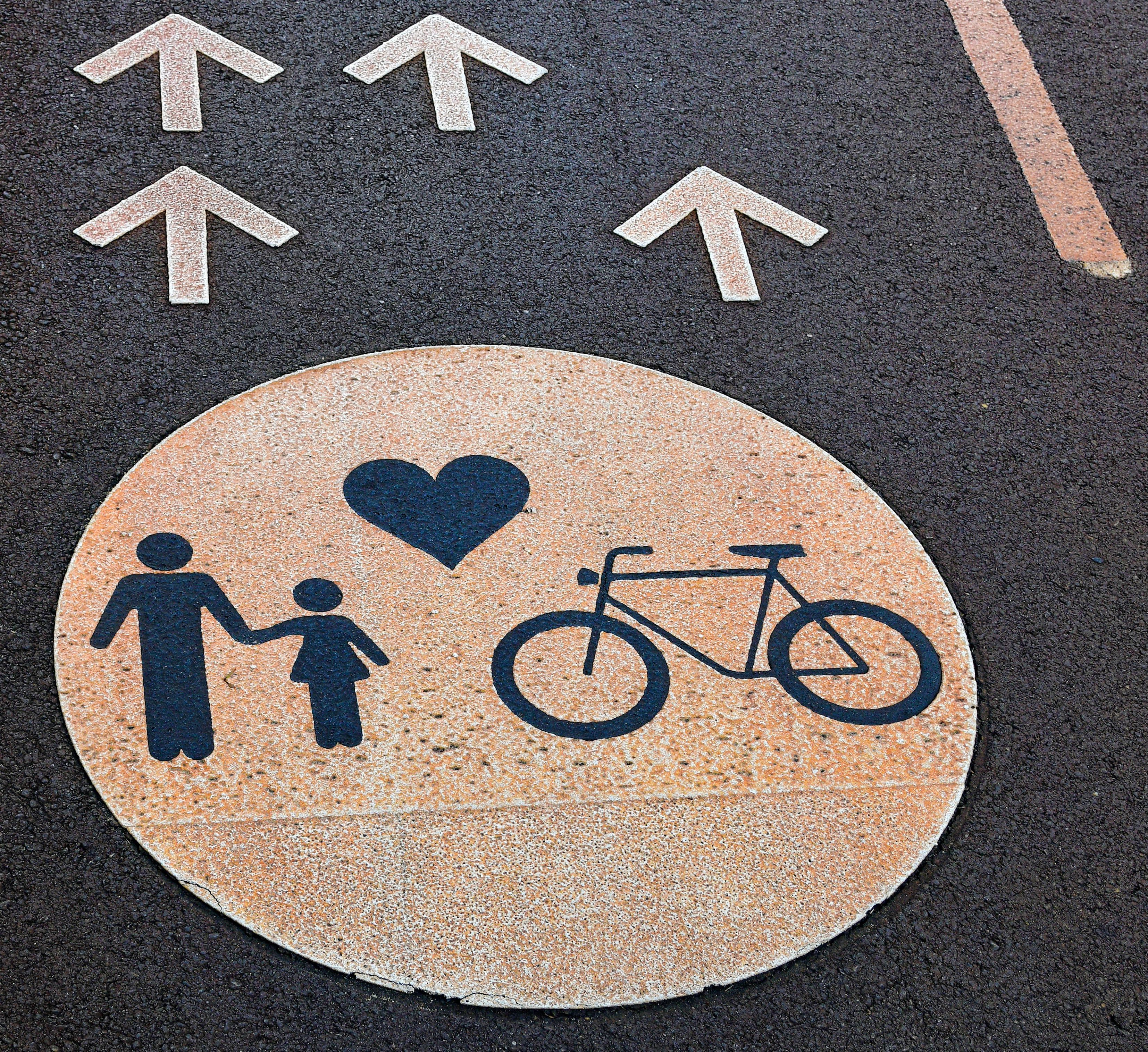 a person riding a bicycle down a street